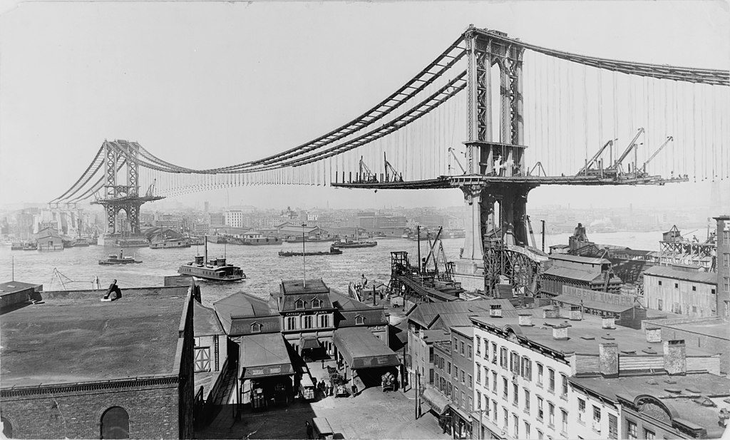 Manhattan Bridge, made March 23rd, 1909. Marine terminal at Main and Plymouth Streets in foreground; bridge under construction in background.